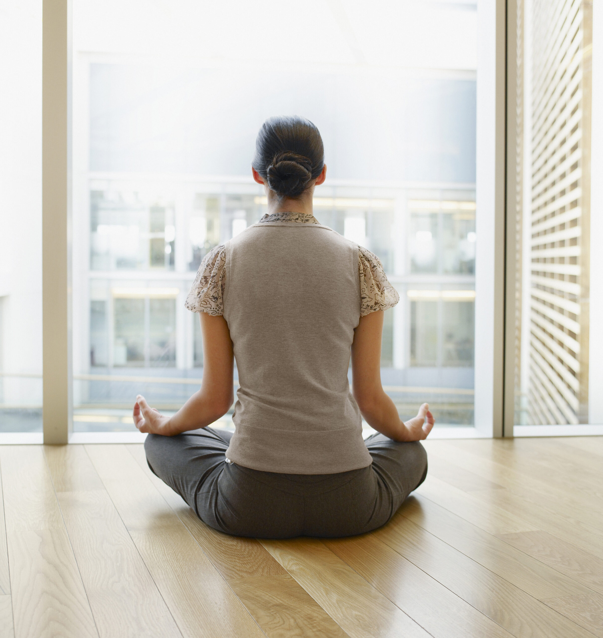 Woman Doing Yoga in Modern Office