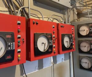 Computers and/or gauges monitor the sample pieces of wood