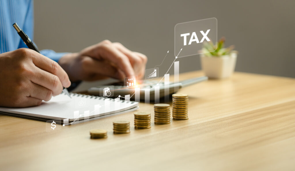 Businessman calculating annual taxes and paying taxes. Tax deduction planning concept. Expenses, account, VAT, income tax, Calculation of taxes, expenses, exemptions, deductions, donations