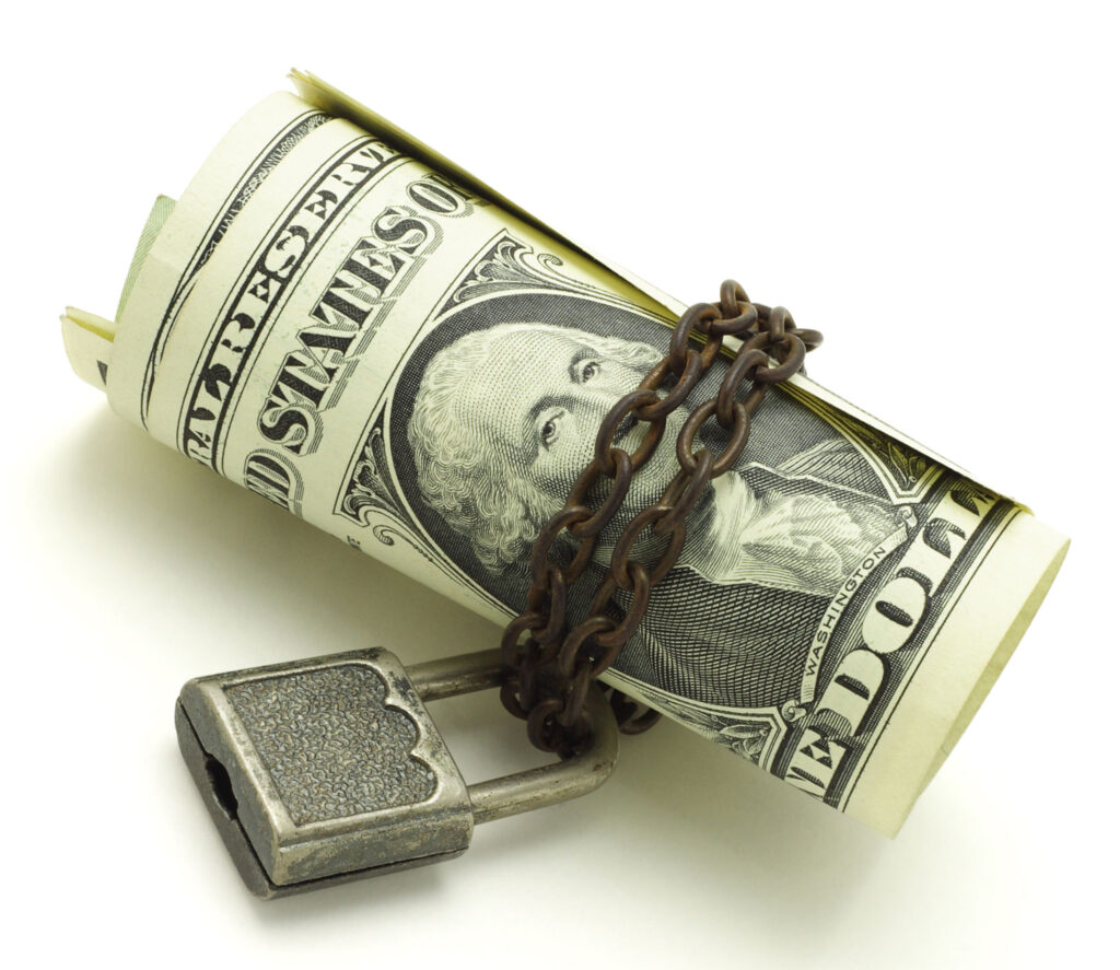 US dollars chained and locked on white background