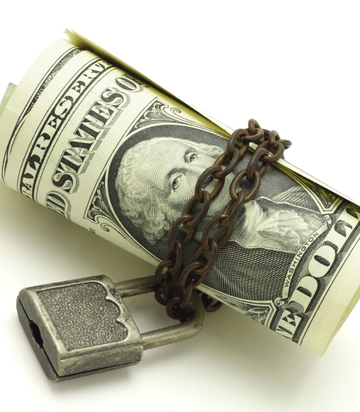 US dollars chained and locked on white background