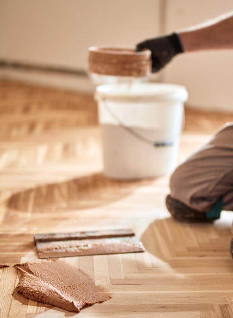 Repairman restoring old parquet hardwood floor.