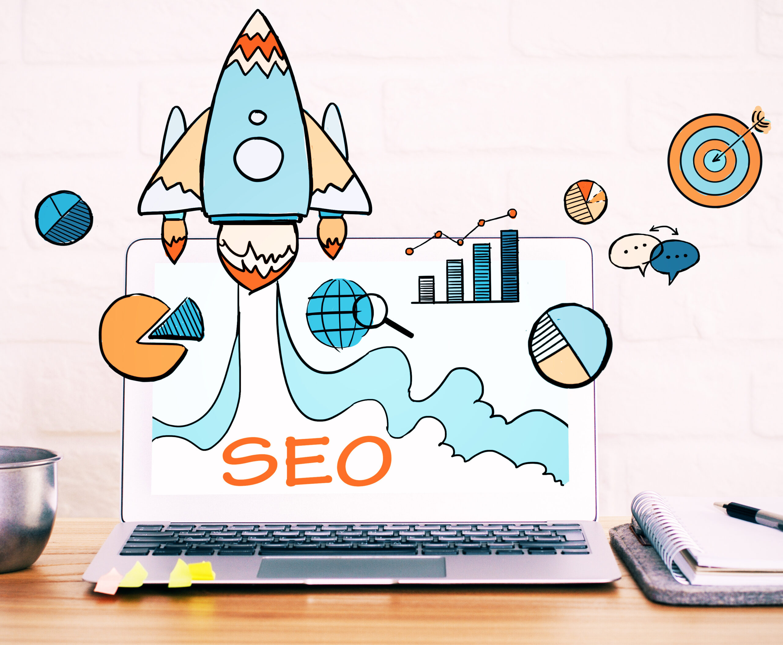 Close up of creative designer desktop with SEO spaceship hologram on laptop screen, coffe cup and other items on white brick wall background. Startup and web concept