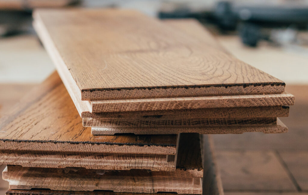 The process of house renovation with changing of the floor from carpets to solid oak wood. Beautiful golden handscraped oiled European oak brushed for added texture and fine definition of wood grain