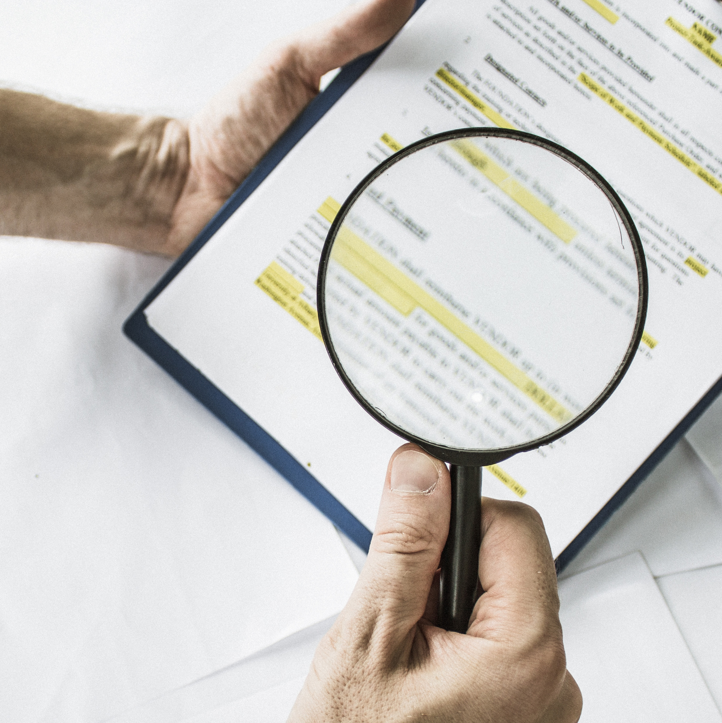 Legal team checking the fine print on business contract to analyze terms and conditions and sign.